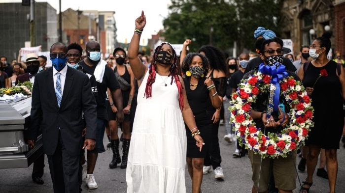 Dannielle Brown, center, marching in mock funeral on Day 34 of her hunger strike. Taken from Google Images